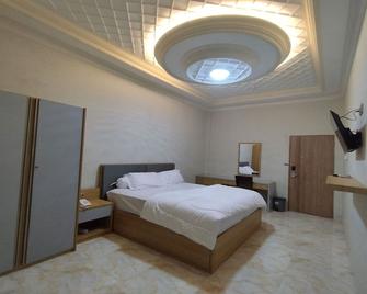 Maulidia Hotel Syariah & Convention Center - Jambi - Bedroom
