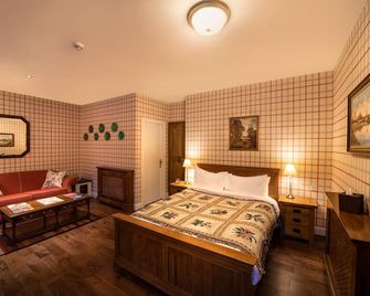 The wooden floors, vintage furniture, and tartan accents create a comfy room - Invergarry