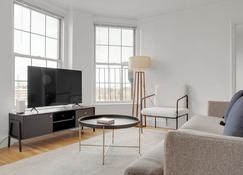 Upscale Brookline 1BR w/ W/D, steps to Green Line, by Blueground - Boston - Living room