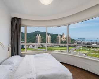 Dalian Yipin Xinghai Edian Apartment - Dalian - Schlafzimmer