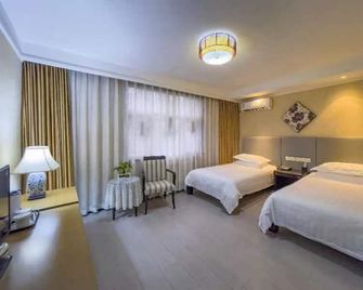 Taihua Business Hotel (Shijiazhuang Xinbai Plaza Mixc Branch) - Shijiazhuang - Schlafzimmer