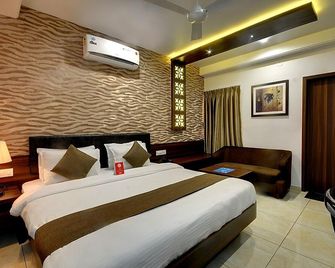 Hotel Cow Residency - Rajkot - Schlafzimmer