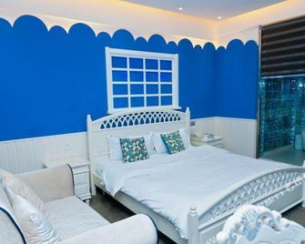 Shijia Boutique Chain Hotel (Kenli Zhongxing Road Store) - Dongying - Bedroom