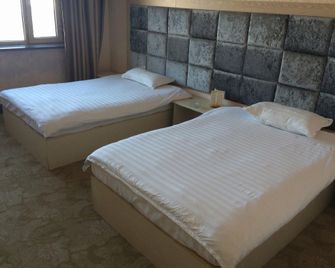 Huadu Business Inn - Songyuan - Bedroom
