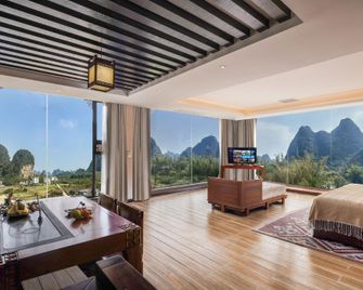 Han Tang Xin Ge Hotel (Shili Hualang Yulong River) - Guilin - Wohnzimmer