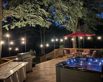 A beautiful recently remodeled home nested on a wooded river lot with a hot tub. - Waupaca