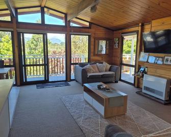 Lockwood holiday house, nestled among lush trees. - New Plymouth - Living room