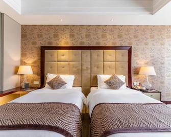 Xinhua Jianguo Hotel - Jiujiang - Slaapkamer