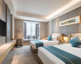 Shiyan Jiahua Holiday Hotel (Wuyan Shopping Mall People's Hospital Branch) - Shiyan - Camera da letto