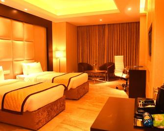 The Gulmohar Grand Hotel - Una - Bedroom