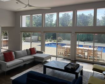 Resort-like home with NEW KITCHEN, private tennis court, heated pool, & hot tub - East Quogue - Living room