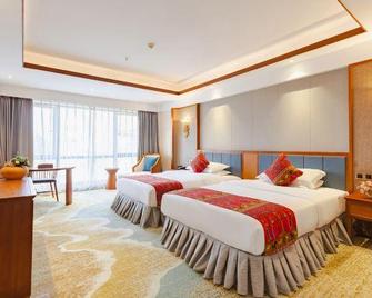Taigu International Hotel - Xishuangbanna - Schlafzimmer