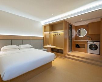 Free Hotel (Shanghai Bailian Central Shopping Plaza ) - Sjanghai - Slaapkamer