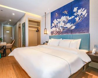 Qingzhu Hotel (Zaozhuang West Station Wanda Plaza) - Zaozhuang - Slaapkamer