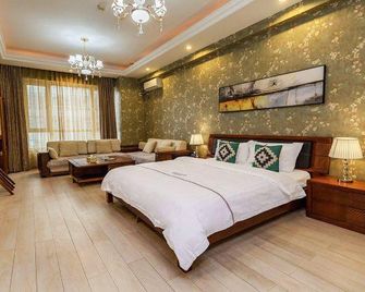 Xingangjing Apartment Hotel(Dalian Harbor Plaza International Conference Center store) - Dalian - Schlafzimmer