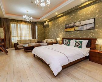 Xingangjing Apartment Hotel(Dalian Harbor Plaza International Conference Center store) - Dalian - Bedroom