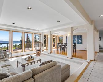 Stunningly situated home with expansive deck & mountain/water views - Oak Harbor - Living room
