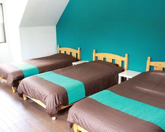 Nangoku Lodge Booya - Onna - Schlafzimmer