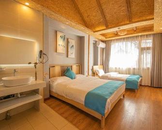 Wolong Inn - Lijiang - Schlafzimmer