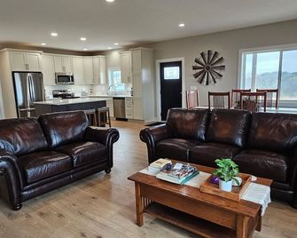Modern home on acreage with pond, trails, rolling hills, and sunset views - Winterset - Living room