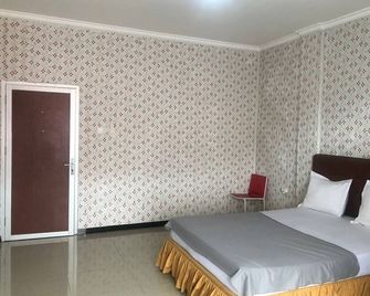 Hotel O Madina Homestay - Samarinda - Camera da letto