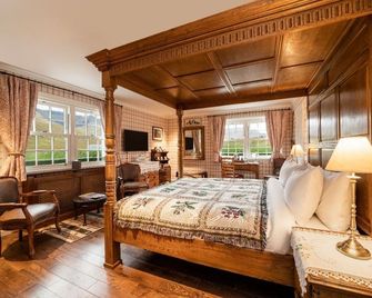 The wooden floors, vintage furniture, and tartan accents create a comfy room - Invergarry