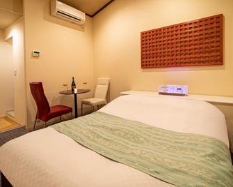 Hotel Rakuseki Honkan - Toyooka - Slaapkamer