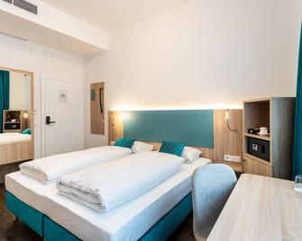 داون تاون رومز - سيلف تشيك إن - فيينا - غرفة نوم