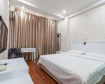 Xihaian Business Hotel - Liangshan - Schlafzimmer