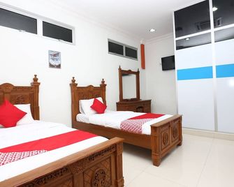 오요 89435 누산타라 그룹 호텔 - 즈띠 - 침실