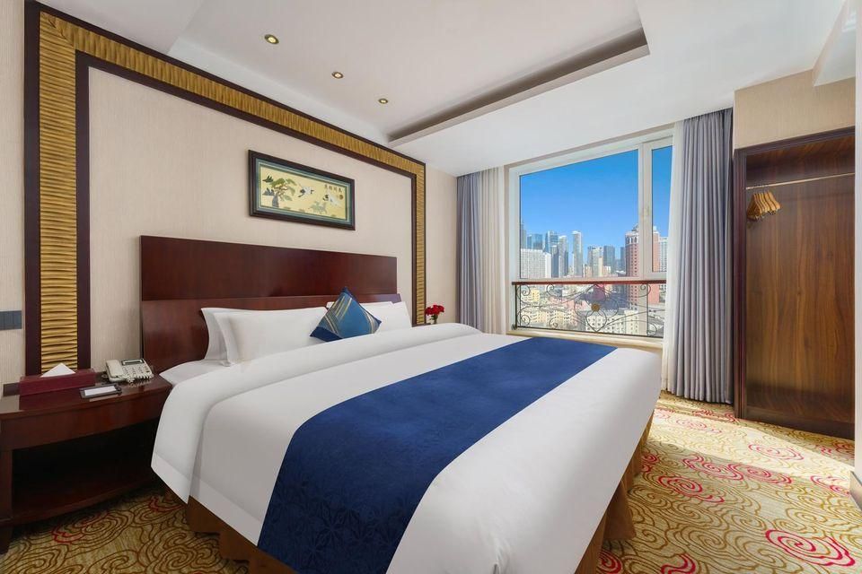 Xinwenyuan Hotel - דאליין - חדר שינה