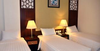 Dar Al Shohadaa Hotel - Medine - Yatak Odası