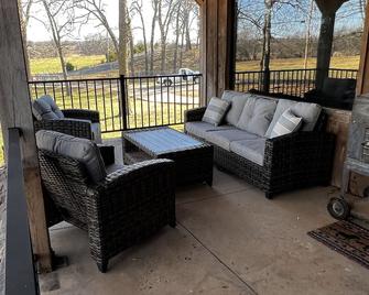 Rustic Lodge with a view of open pastures and bison grazing on the land. - Wyandotte - Living room