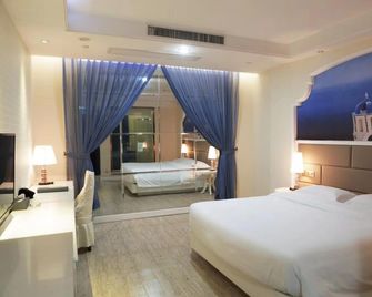 Huajun Hotel - שיאמן - חדר שינה