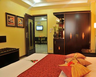 Urban Rose Hotel and Apartment - Daressalam - Schlafzimmer