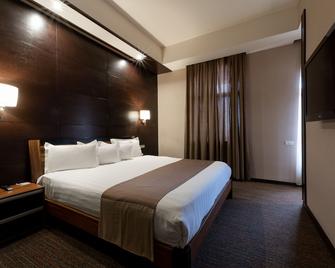 Bass Boutique Hotel - ירבאן - חדר שינה