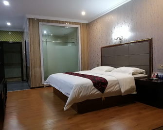 Yixing Business Hostel - Foshan - Bedroom