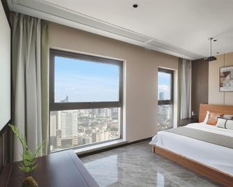 M·City Boutique Cinema Hotel (Nanjing Olympic Sports Center Branch) - Nanjing - Bedroom