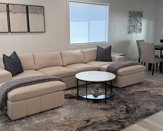 Experience elevated comfort in this thoughtfully designed retreat. Featuring two inviting bedrooms, a fully equippedbrkitchen, and serene details, it blends simplicity with style for a clean, welcoming stay. - Burley - Living room