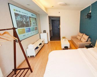 Qingdao Hong Ding Yijia Holiday Apartment - Qingdao - Habitación