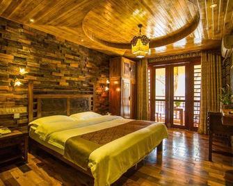 Fengweizhu Inn - Xishuangbanna - Bedroom