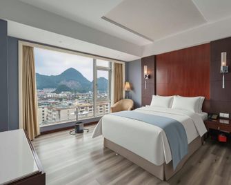 Times Holiday Hotel - Liupanshui - Bedroom