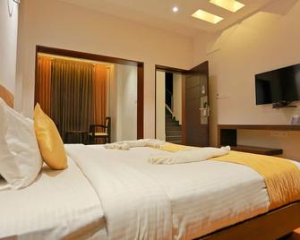 Grand Signature Hotel & spa - Yercaud - Спальня