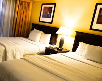 Garden Inn & Suites - קווינס - חדר שינה