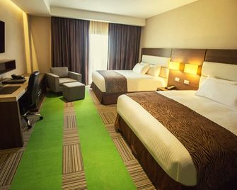 يوروبويلدينج هوتل آند سويتس كورو - كورو - غرفة نوم